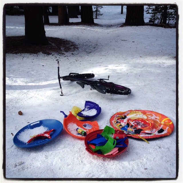 Collecting broken and discarded sleds along the trail.